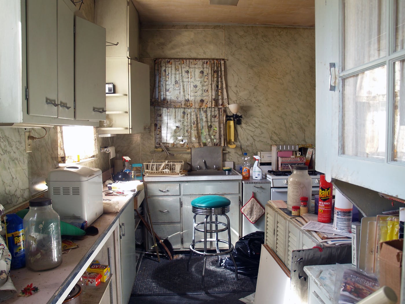 The original 1928 kitchen — barely ten feet wide, with an awkward L-shaped layout